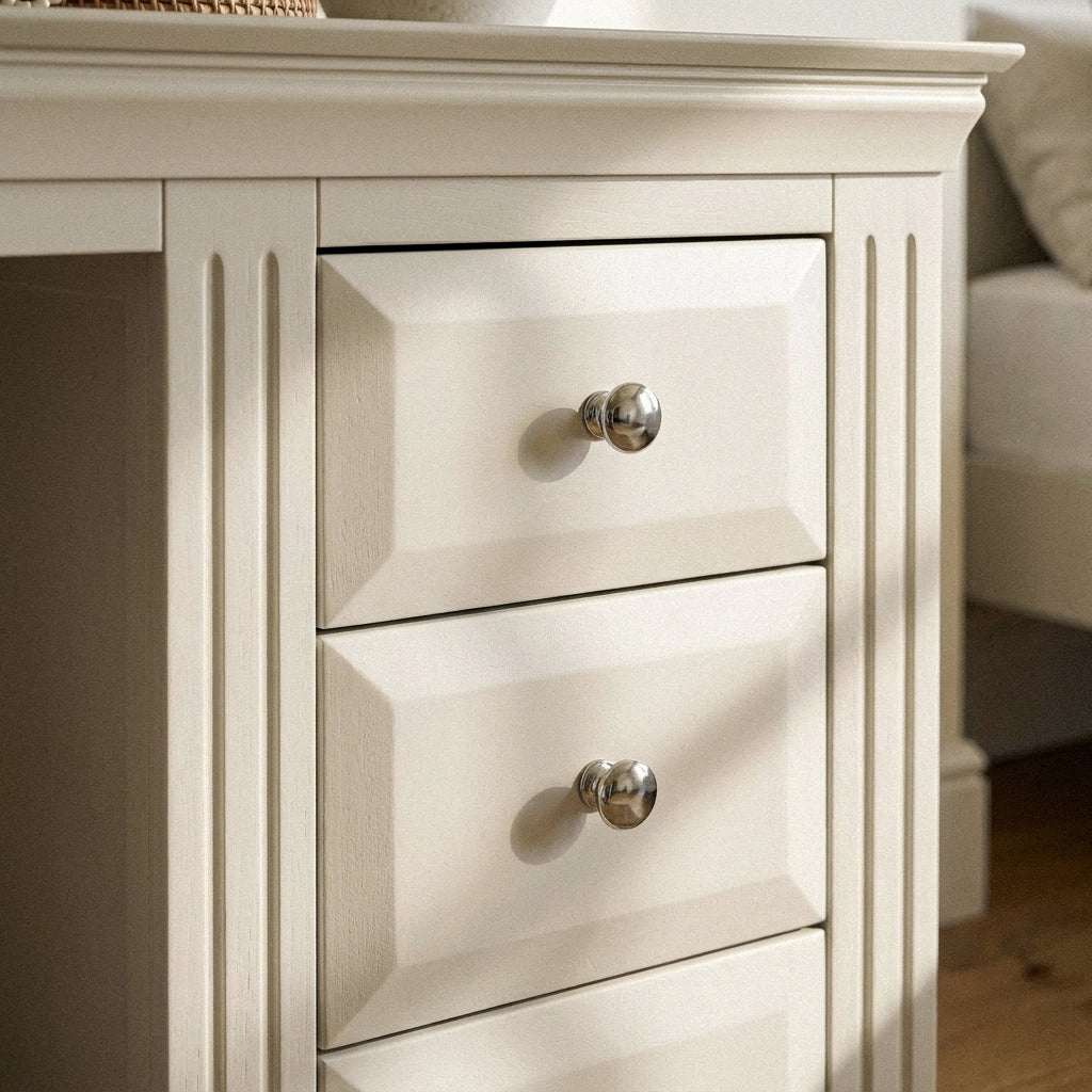 Close-up of the three drawers and chrome knobs