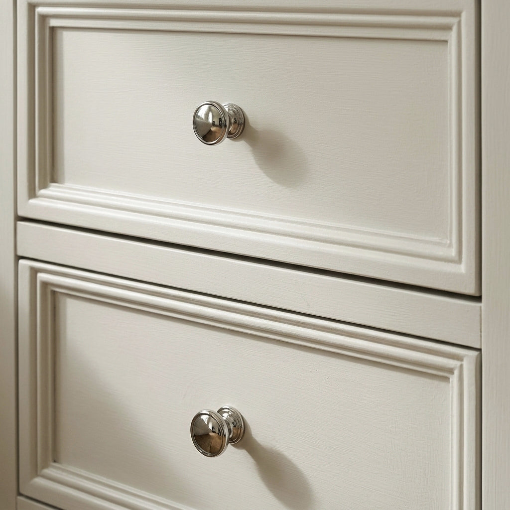 Close-up of the two panelled drawer fronts and chrome knobs