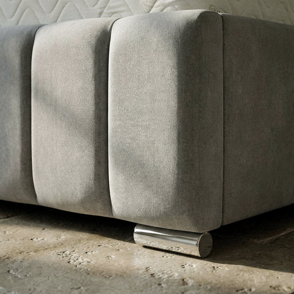 Close-up of the channelled footboard and chrome foot on the Zola bed frame