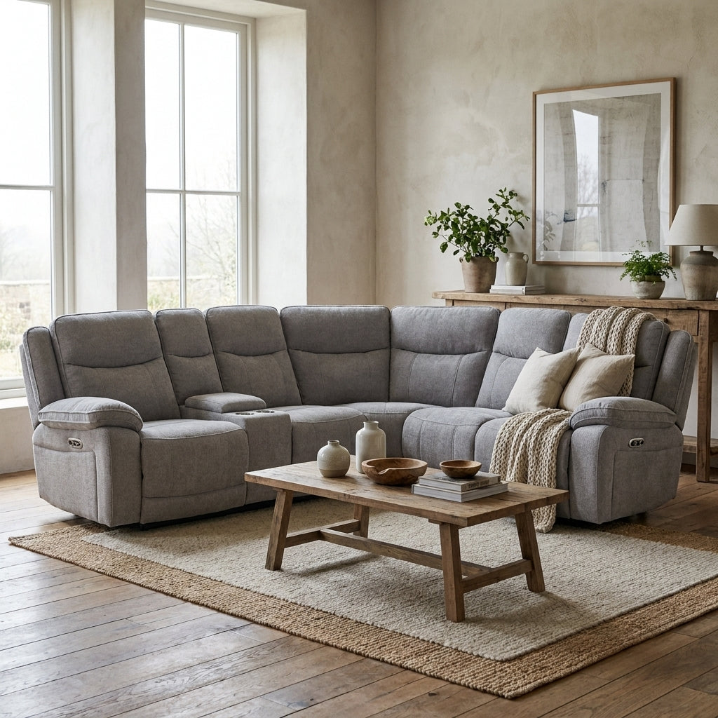 Modern farmhouse living room featuring a cozy grey sectional sofa, rustic wooden coffee table, and natural area rug.