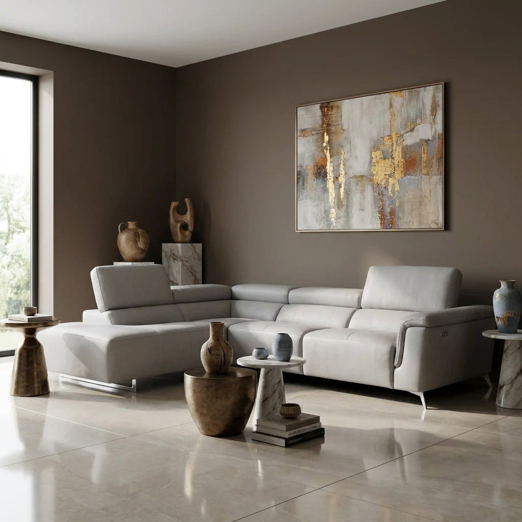 Kimi Corner Sofa in pale grey Italian leather with a left hand chaise, in a living room with deep taupe walls and a polished porcelain floor