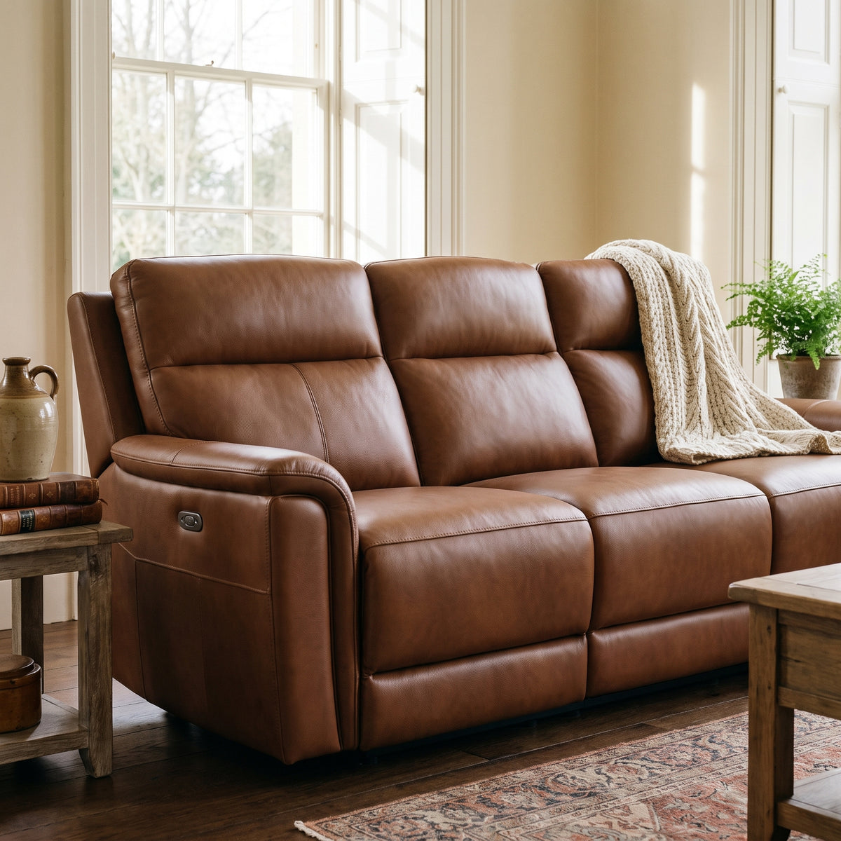 Sterling tan leather electric recliner in a period room with cream walls, dark oak floorboards and a sash window