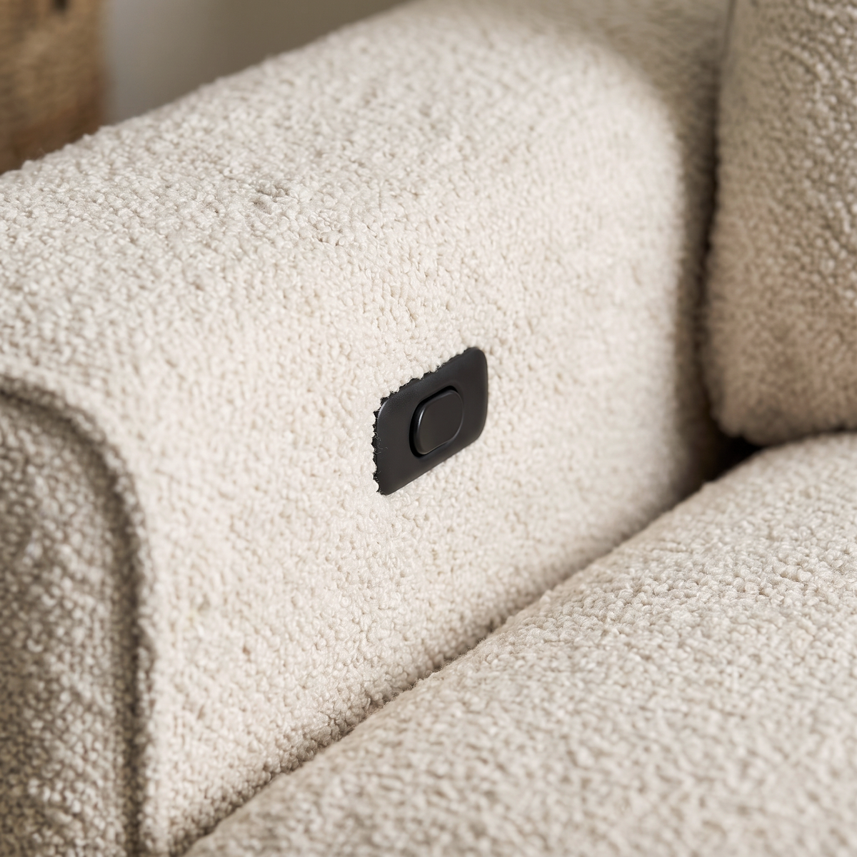 Close up of the control button on the arm and the oatmeal boucle texture of the Arabella sofa bed