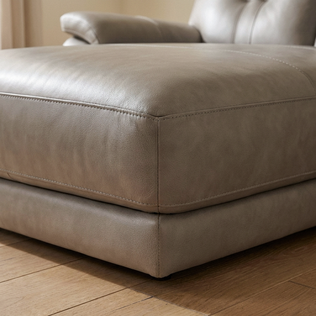 Close up of the base corner and taupe leather grain on the Grace reclining sofa