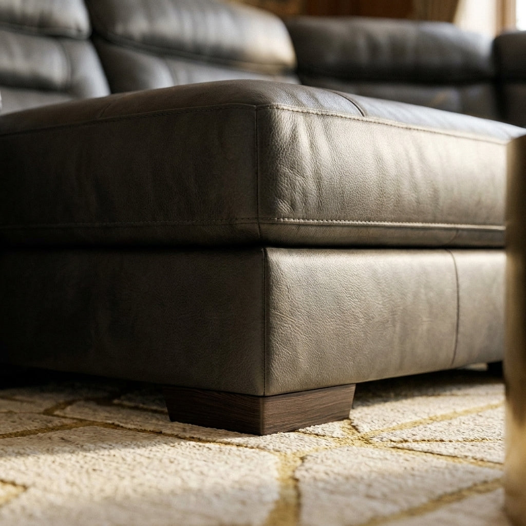 Close up of the base corner, leather grain and wooden foot on the Viridia corner sofa