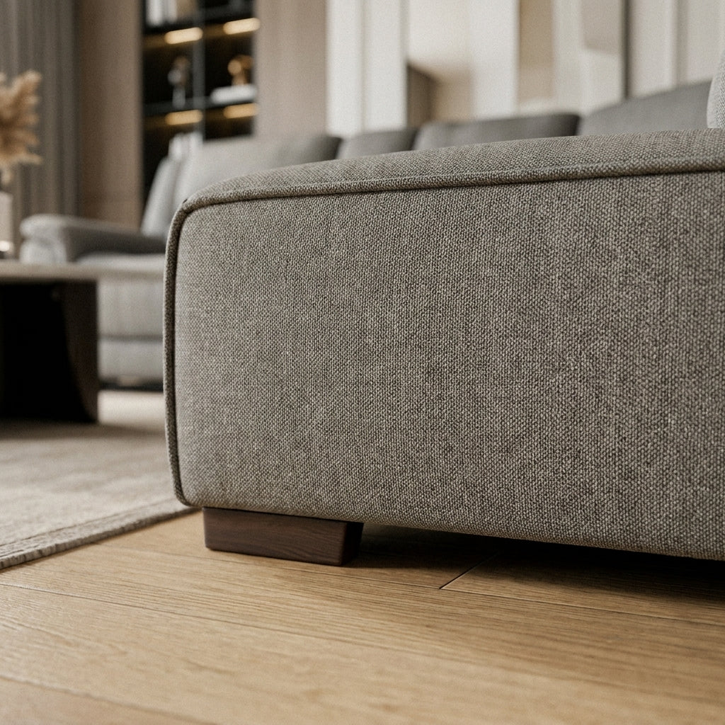 Close up of the piped base corner and woven grey fabric on the Vultan corner sofa