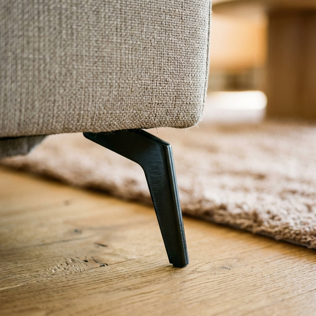 Close up of the slim black splayed metal leg and greige weave on the Oscar corner sofa