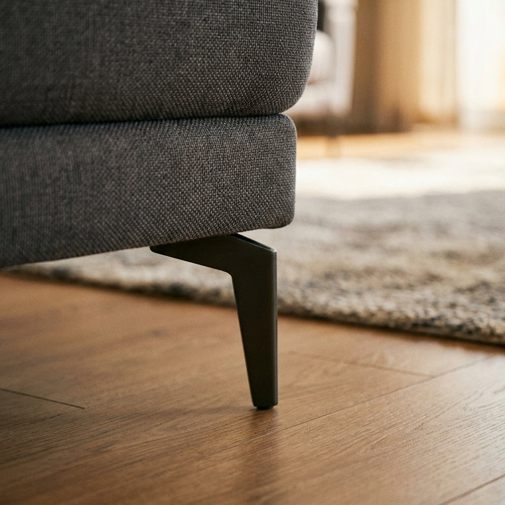 Close up of the slim dark metal leg and charcoal weave on the Warwick lounger