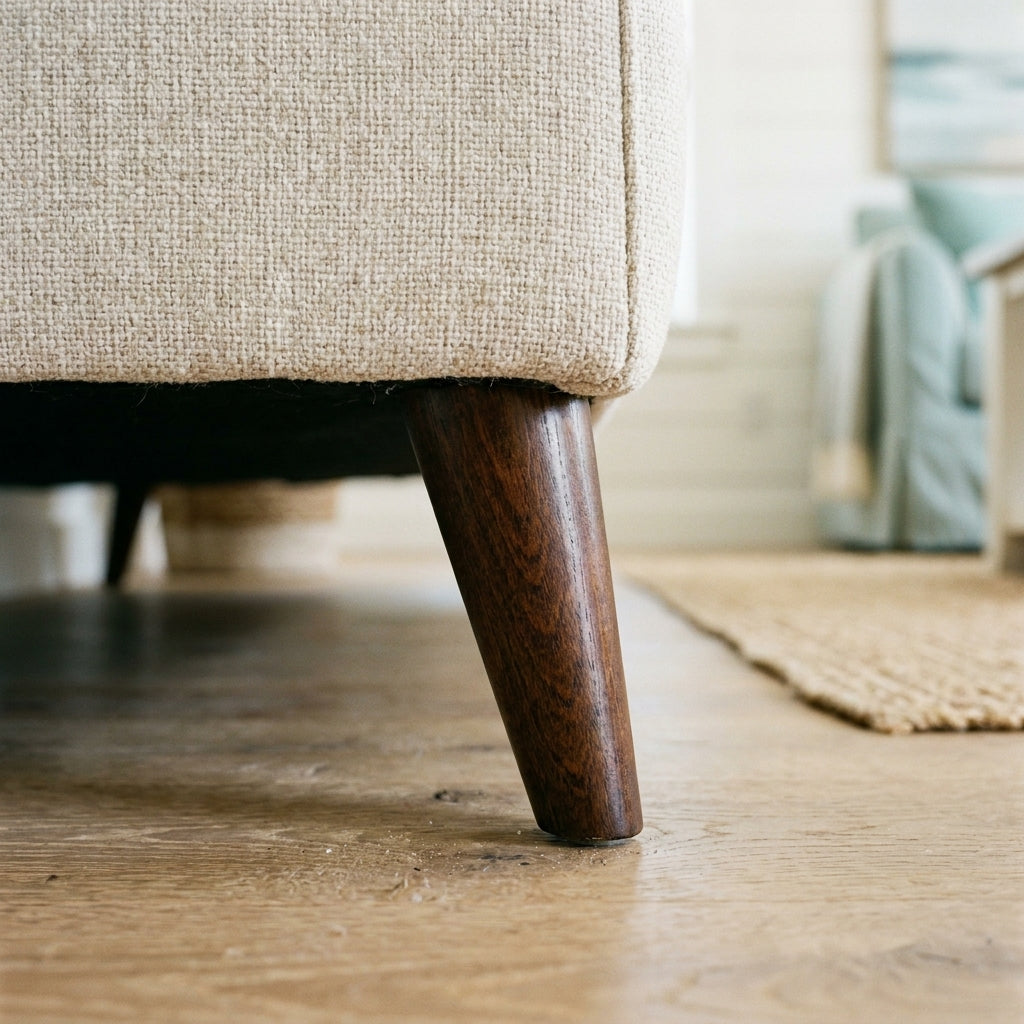 Close up of the dark tapered wooden leg and oatmeal weave on the Samantha sofa