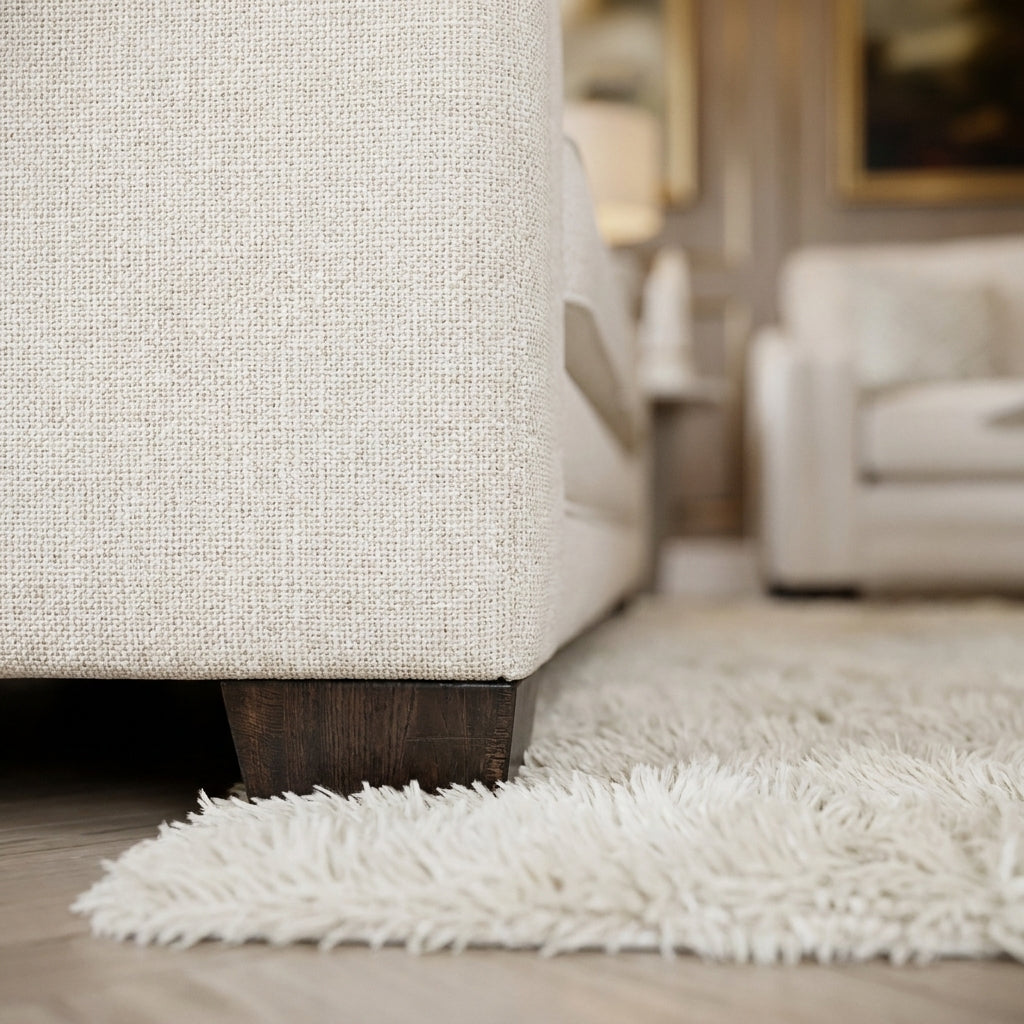 Close up of the low dark foot and ivory cream weave on the Chandon sofa