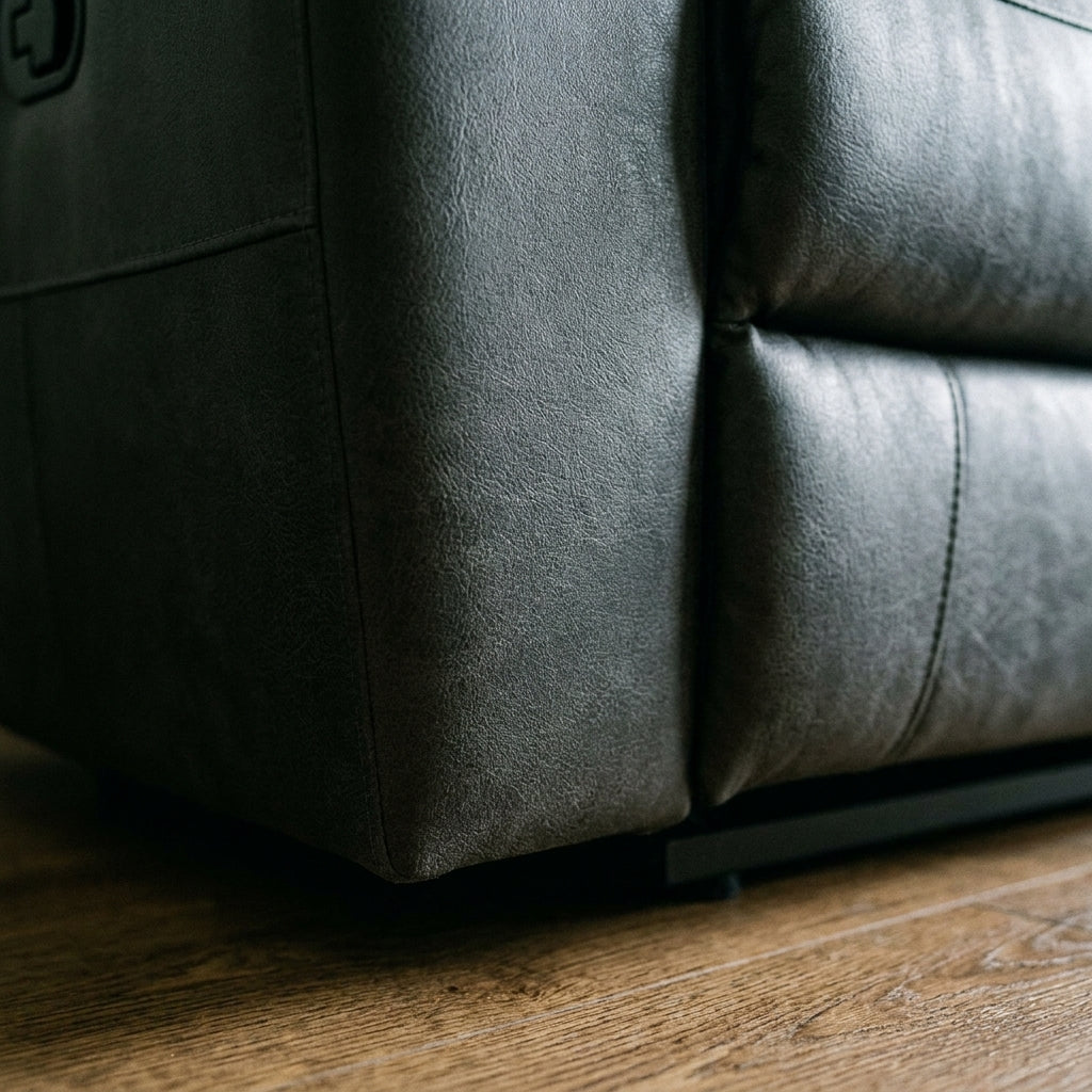Close up of the plinth base corner and charcoal leather look finish on the Tiberius sofa