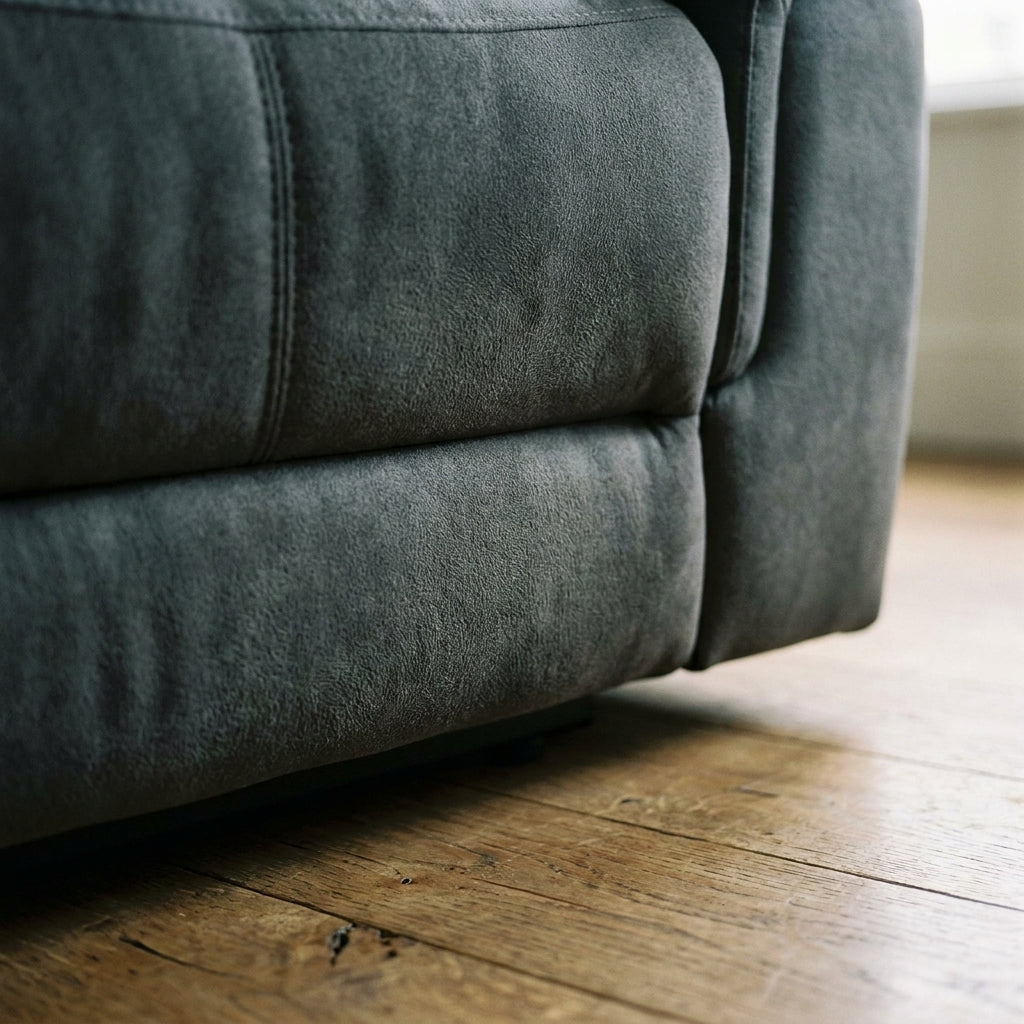 Close up of the plinth base corner and charcoal suede look fabric on the Ash reclining suite