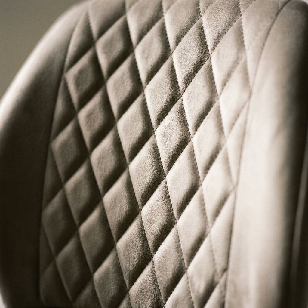 Close up of the diamond quilted stitching on the taupe velvet back of a Casey dining chair