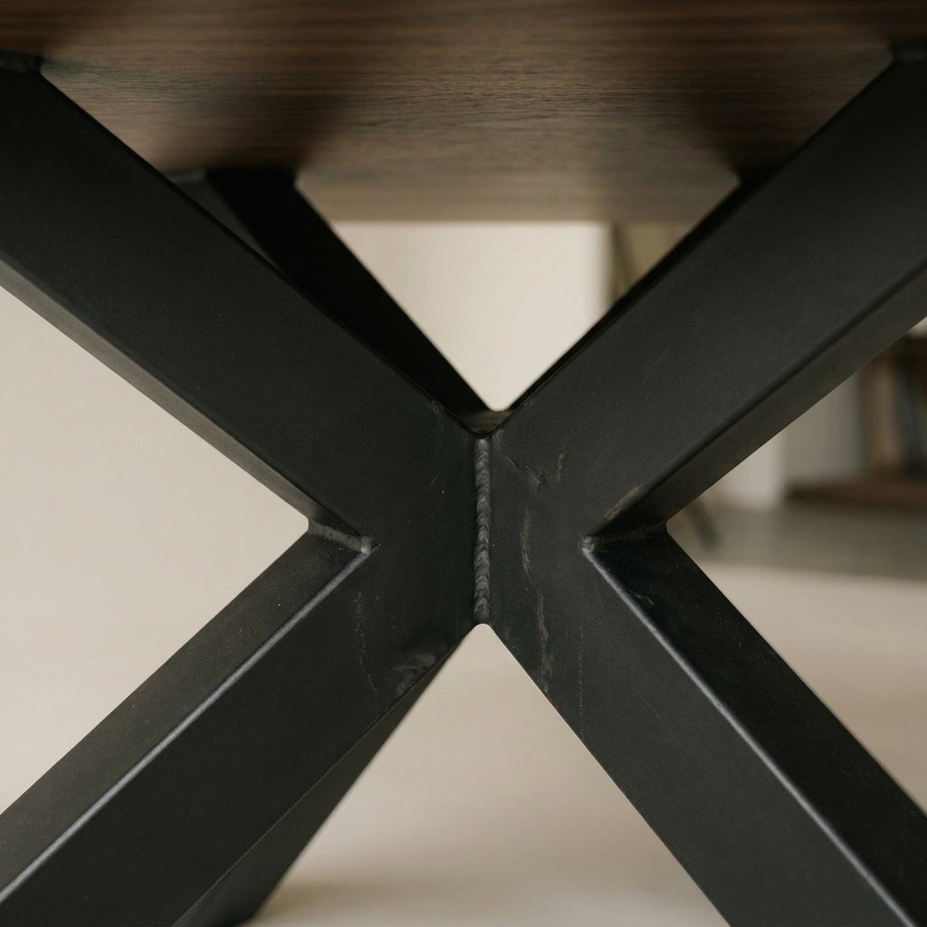 Close up of the black crossed spider pedestal base beneath the Colorado dining table