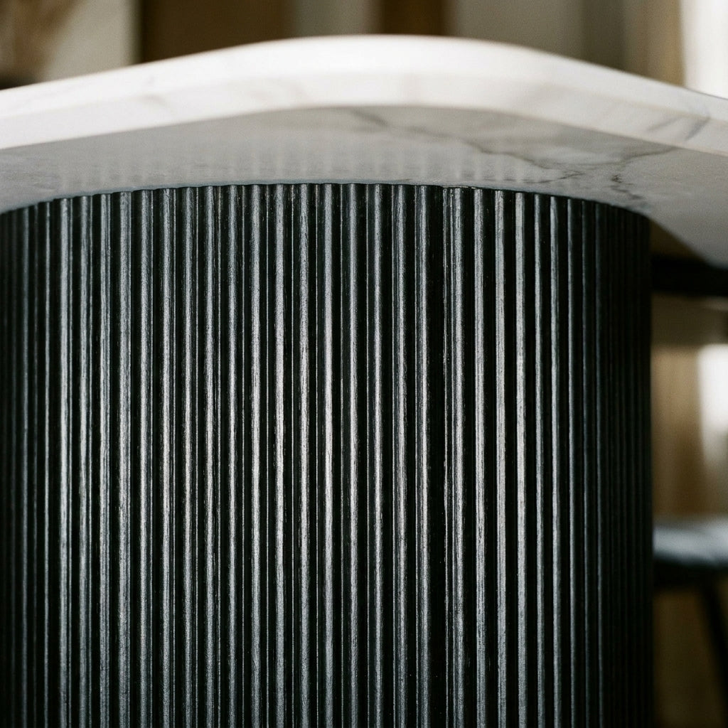 Close up of the black fluted drum pedestal beneath the Moet dining table top