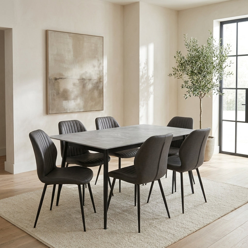 Benson seven piece dining set with a grey sintered stone top and six dark chairs in a bright modern European dining room
