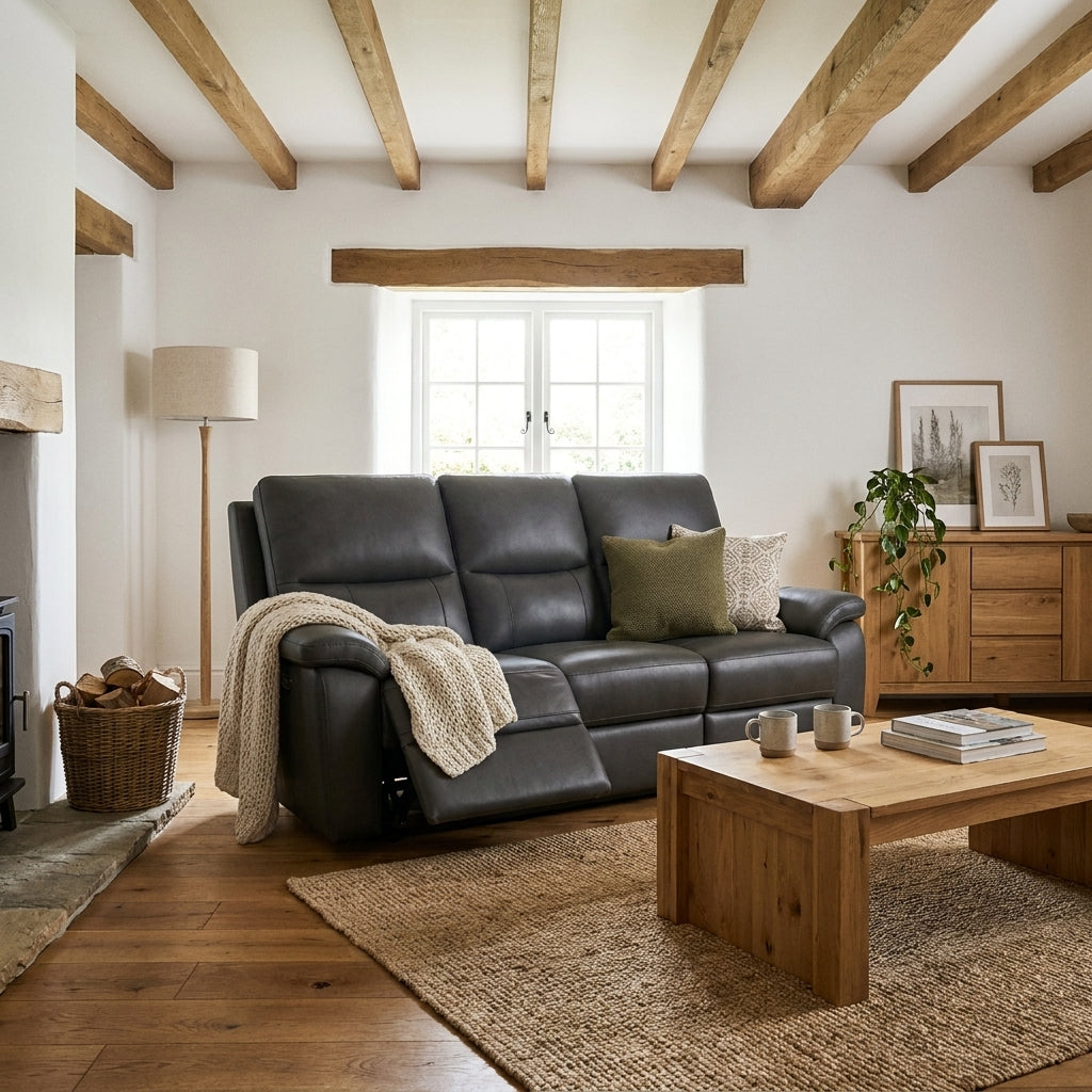 Julius three seat charcoal leather electric recliner with footrest extended in a beamed cottage living room