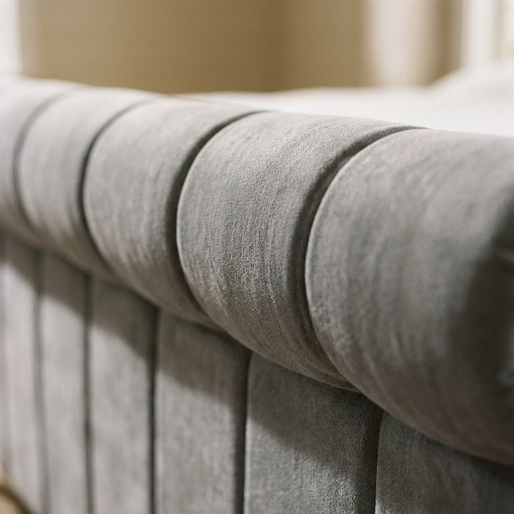 Close up of the Neptune sleigh headboard showing the deep vertical fluting in grey velvet