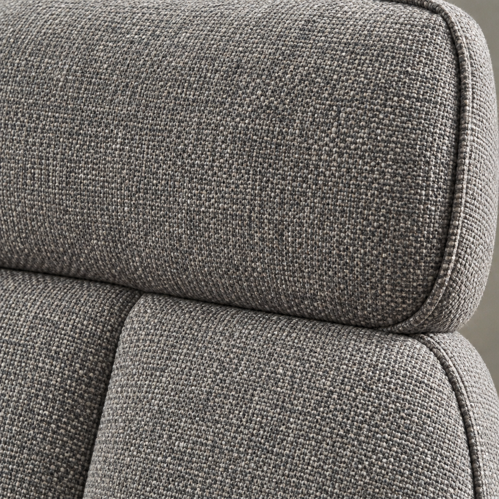 Close detail of the Kirk Swivel Chair's flecked grey woven fabric and the seam where the padded headrest meets the back