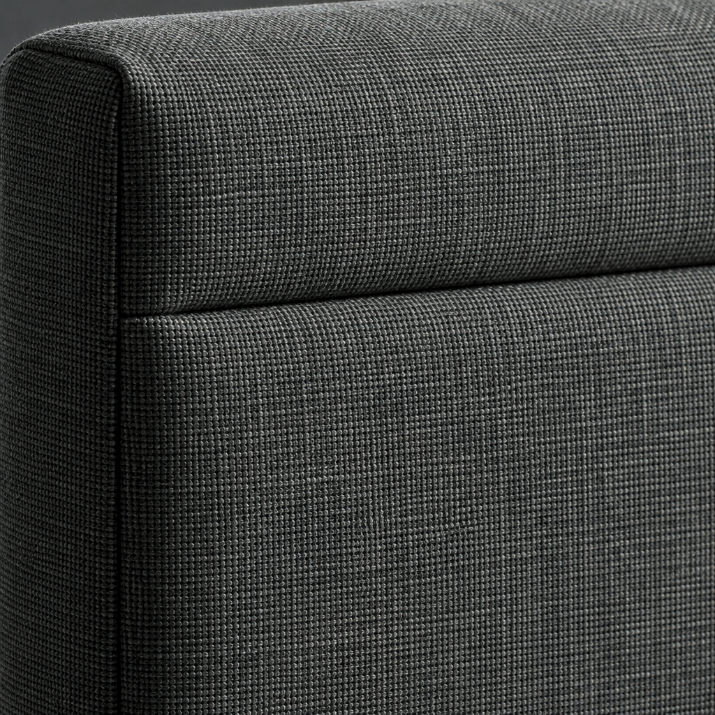 Close detail of the Leia headboard showing the charcoal woven fabric and the horizontal border seam