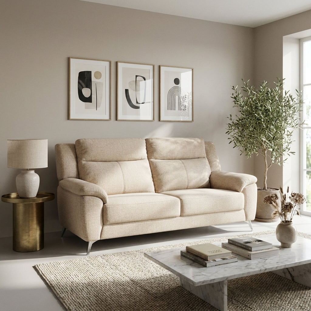 Clarice 3 seat sofa in beige fabric against a living room wall with a marble coffee table and olive tree