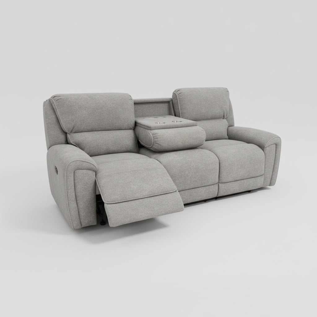 Gray recliner sofa in a living room setting with a rug and wall art.