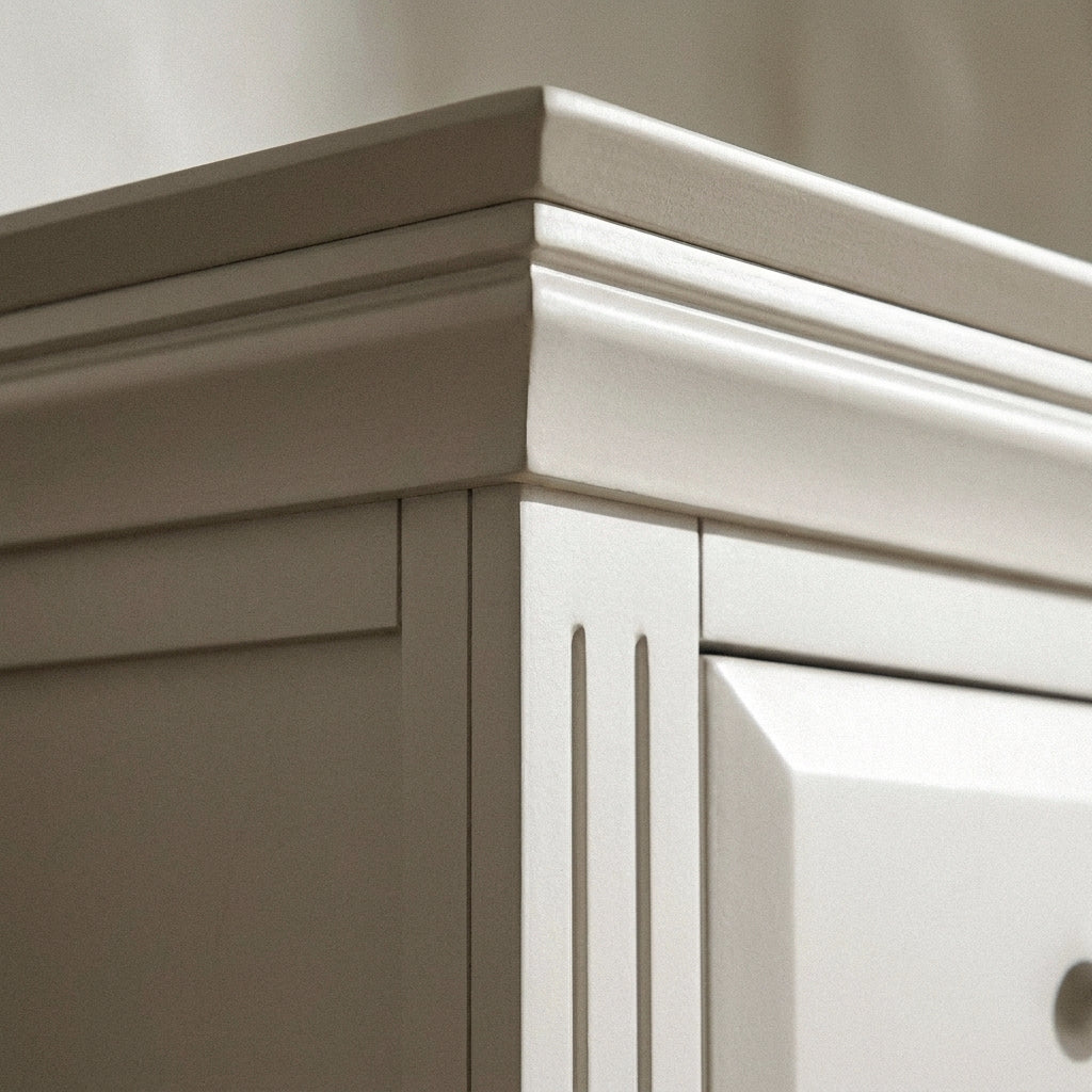 Close-up of the stepped moulded top edge and corner pilaster
