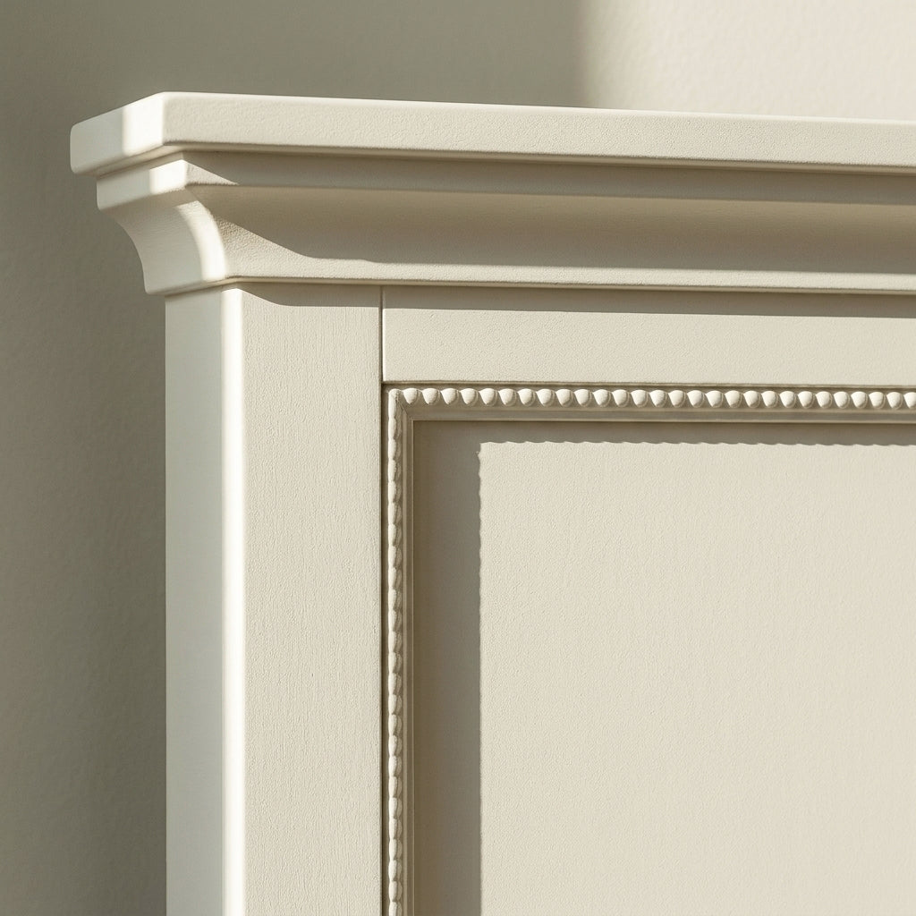 Close-up of the moulded top rail and bead moulding on the headboard