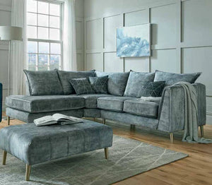 Gray sectional sofa with matching ottoman in a modern living room.