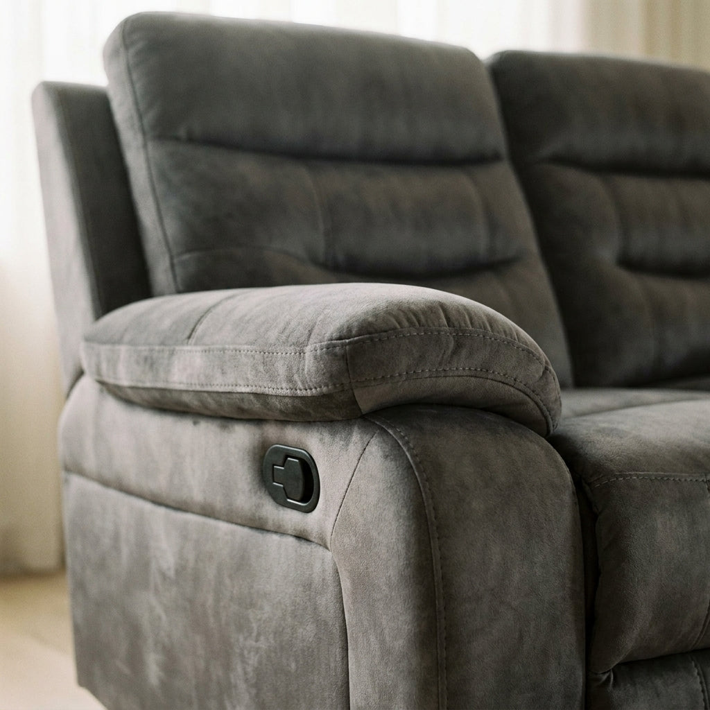 Close-up of a modern gray suede reclining sofa featuring a manual handle, perfect for a comfortable and stylish living room.