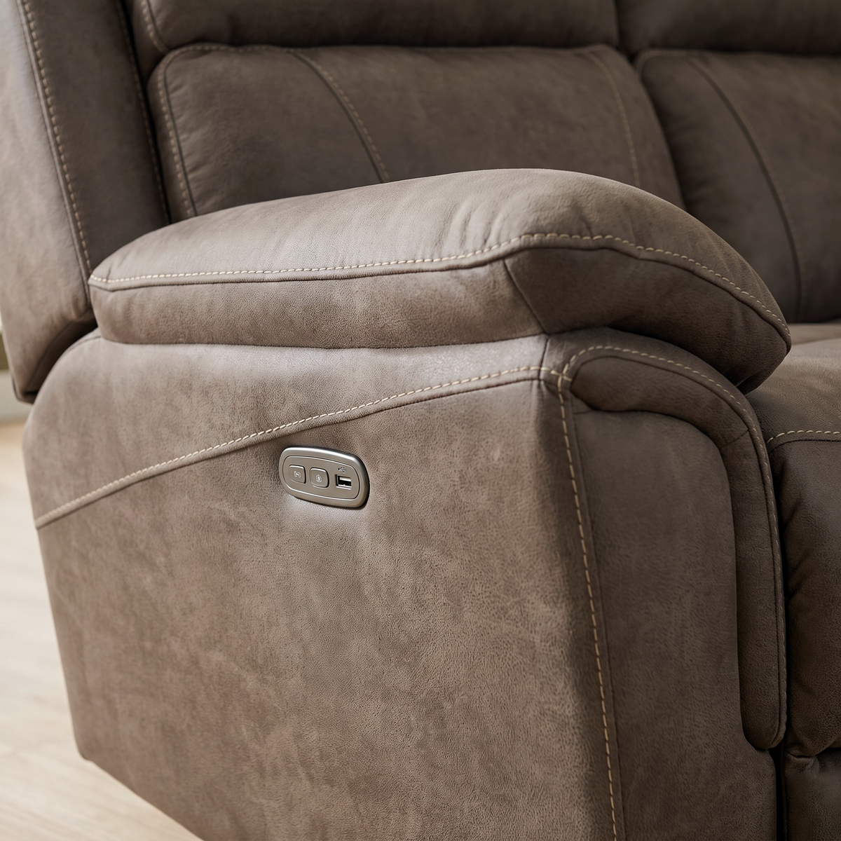 Close up of the Alamo arm showing the electric recline control panel with USB port, and the contrast topstitching on the taupe fabric