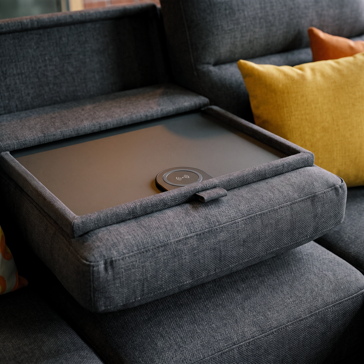 Close up of the Warwick lounger drop down tray with built in wireless charging pad
