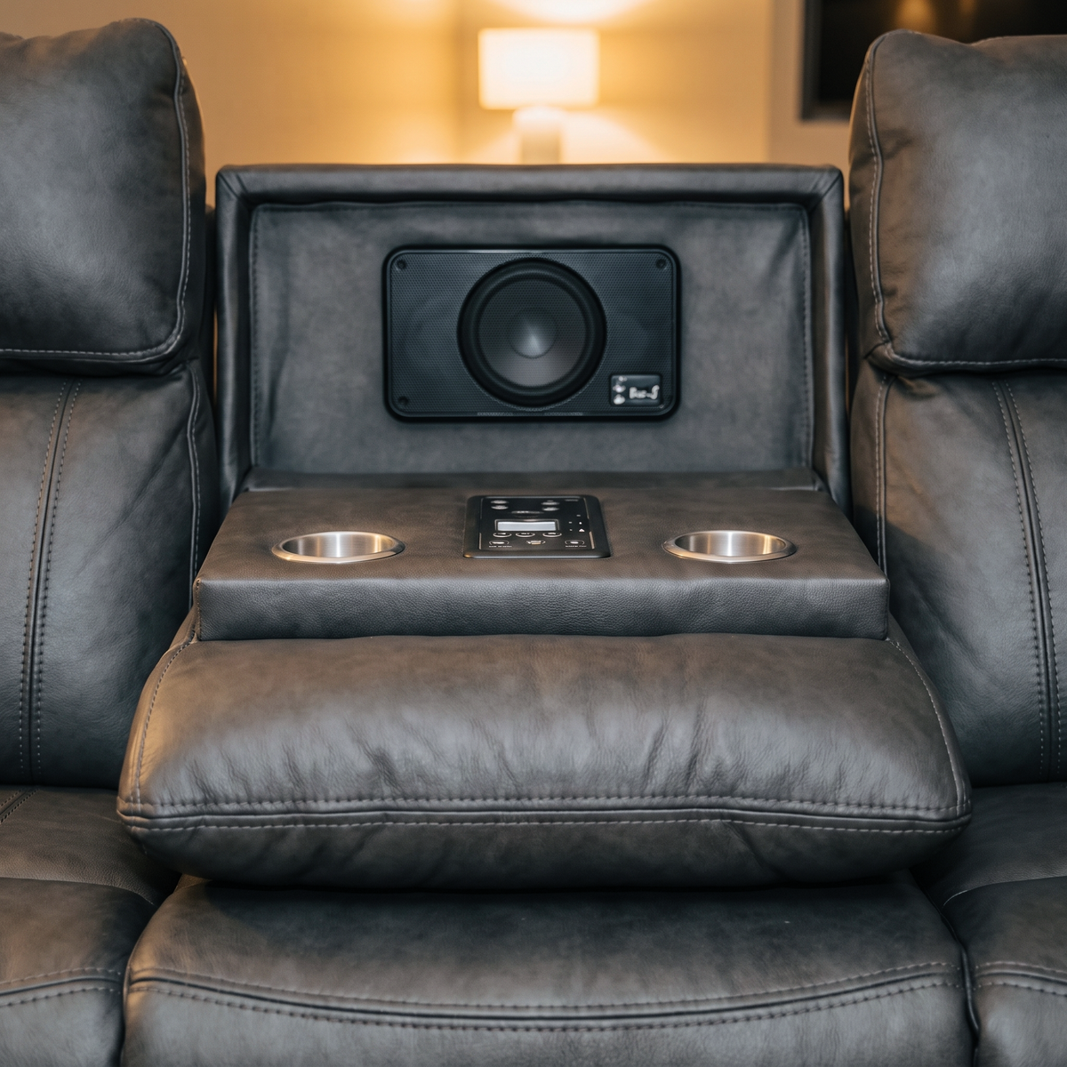 Close up of the Tiberius drop down console with built in speaker, control panel and two cup holders
