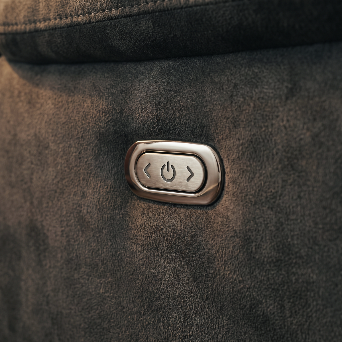 Close up of the chrome power recline button on the arm of the Ash electric reclining sofa