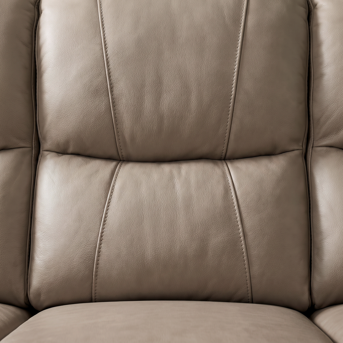 Close up of the quilted panelled back and taupe leather grain on the Sydney reclining sofa