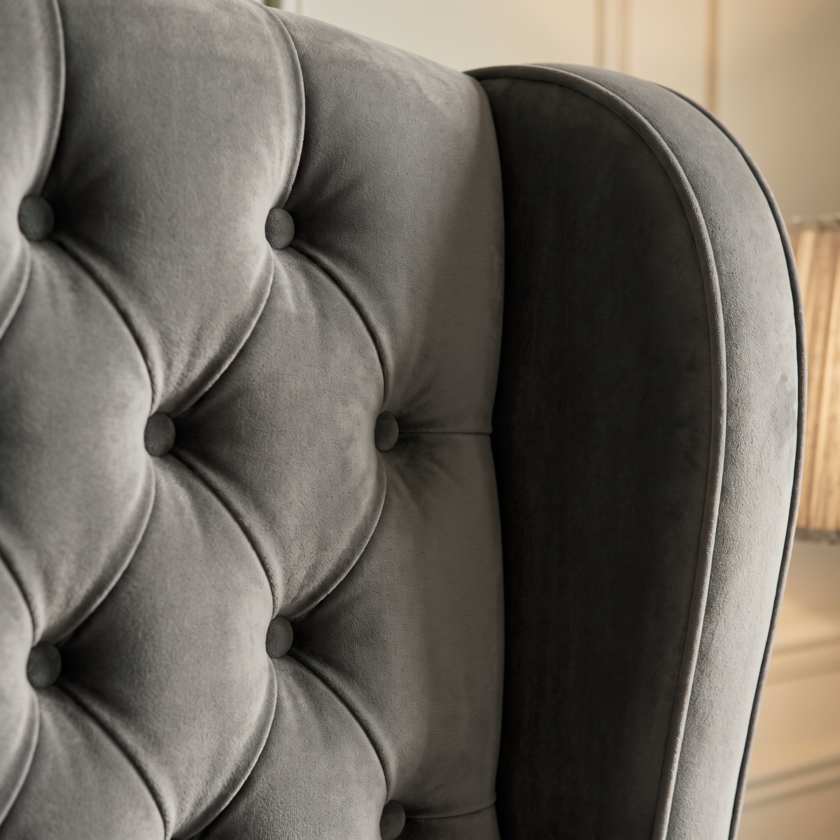 Close up of the diamond button tufting and grey velvet on the Galgorm ottoman bed headboard