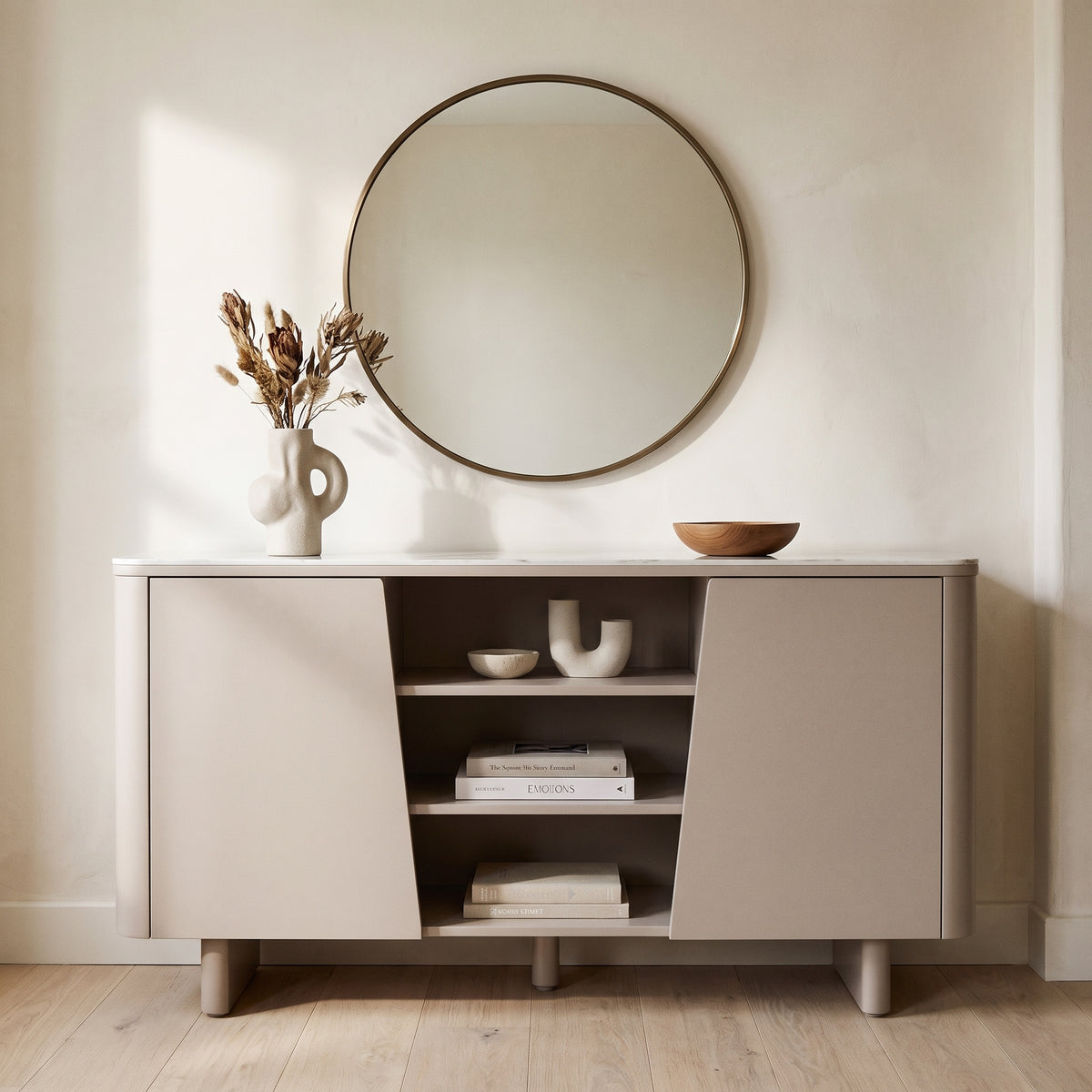 Castello sideboard in soft taupe with a marble top and open central shelving, against a warm off white wall