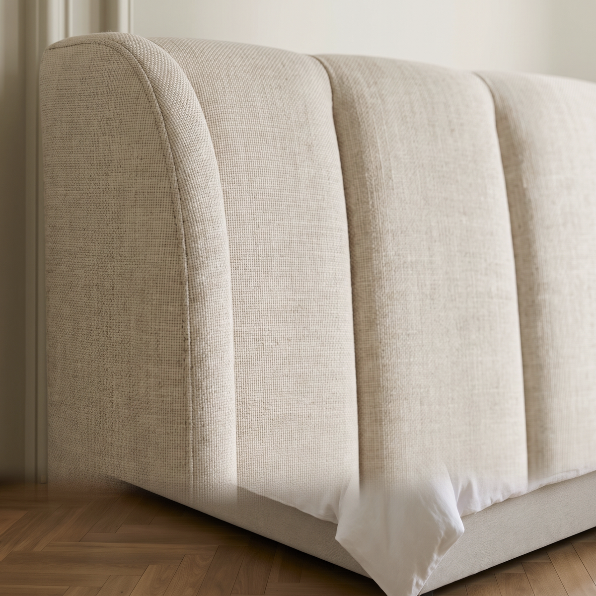 Close up of the fluted channelling and oatmeal linen weave on the Coco ottoman bed headboard