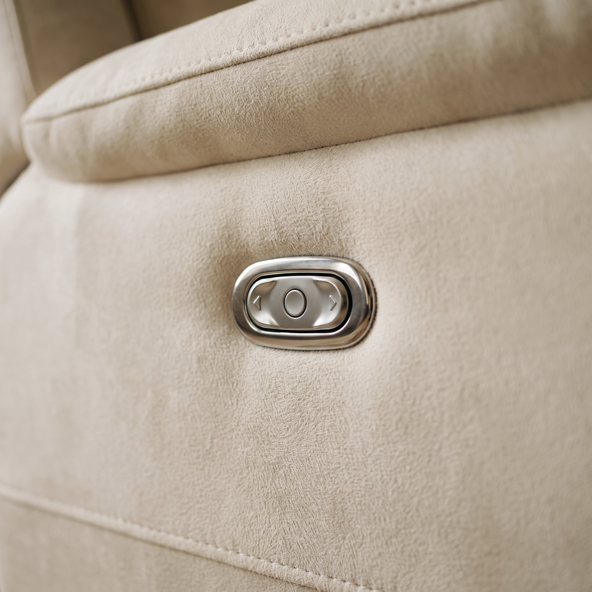 Close up of the chrome power recline button on the arm of the Walton sofa
