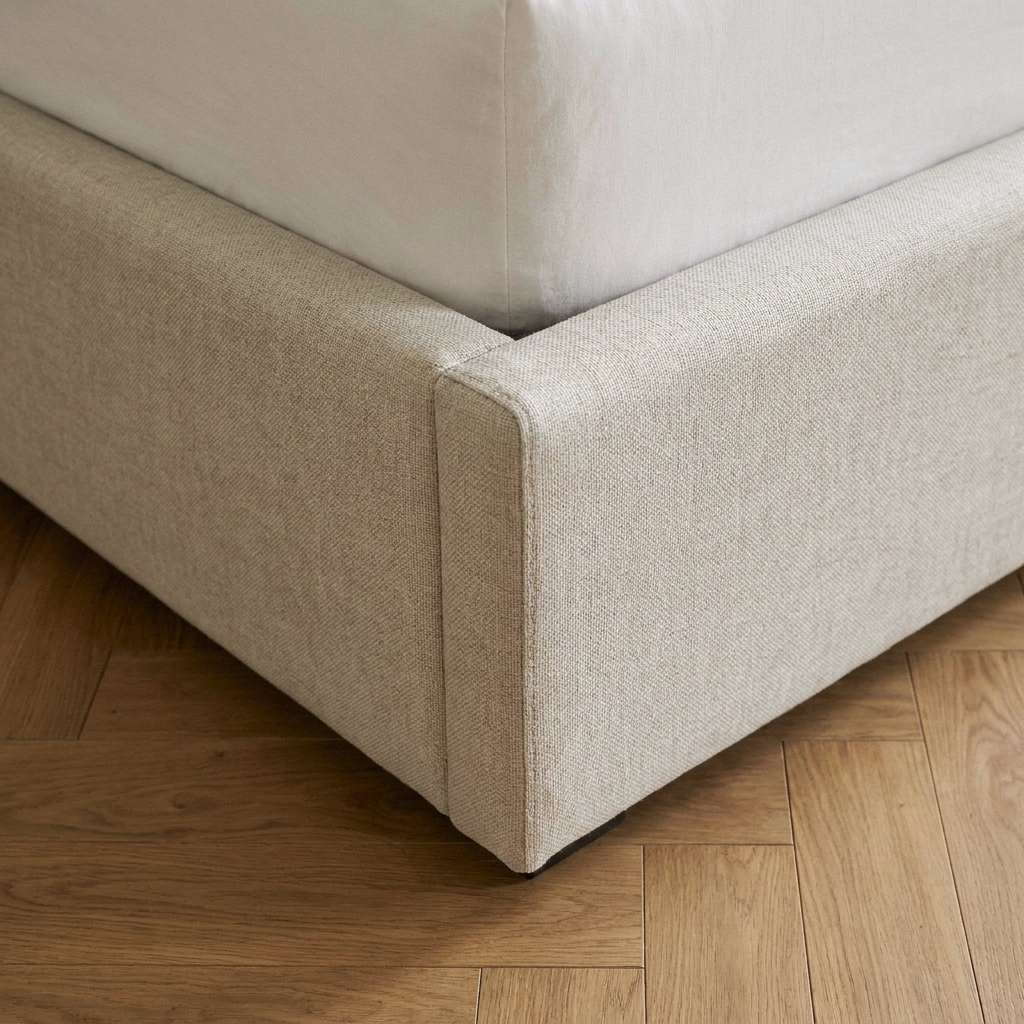 Close up of the bottom corner of the Coco ottoman bed base in oatmeal linen
