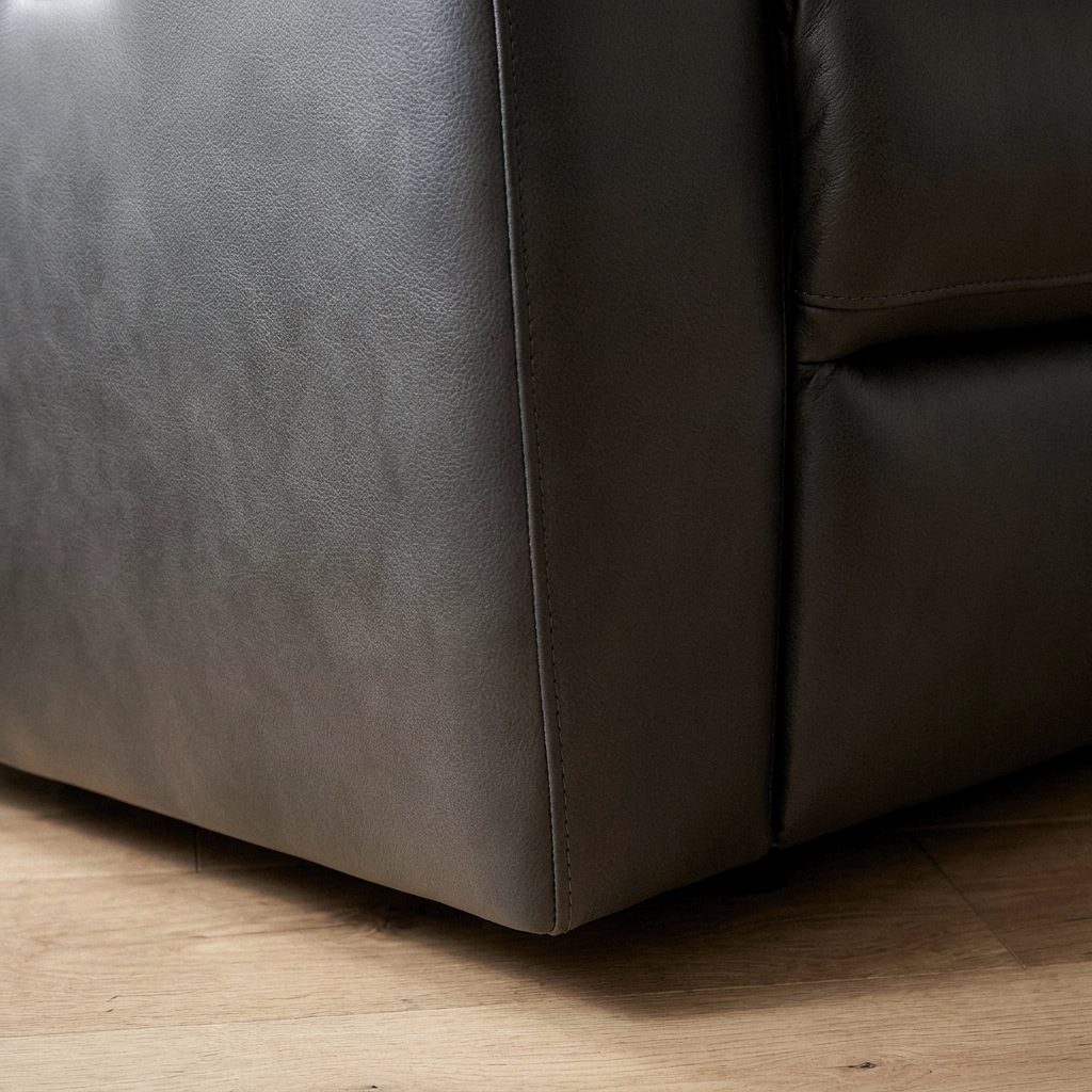 Close up of the base corner and charcoal leather grain on the Julius recliner