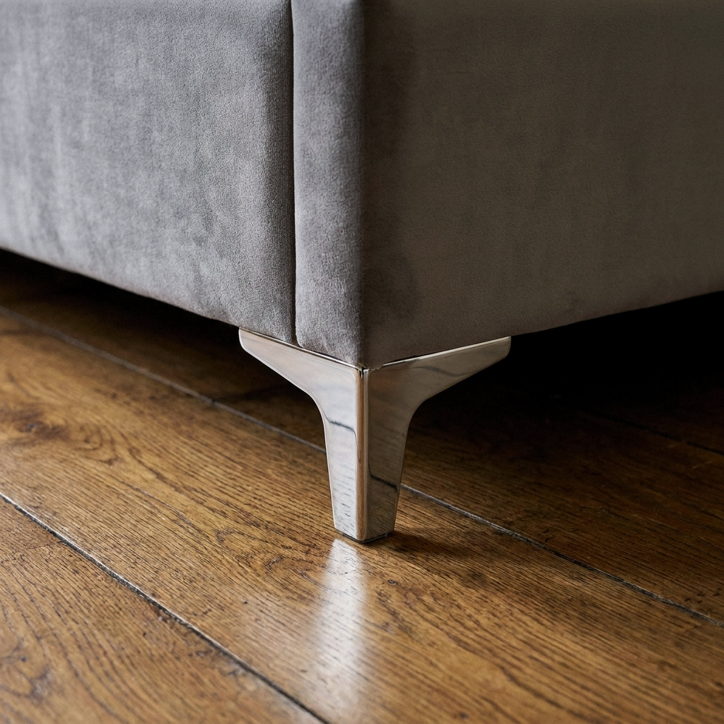 Close up of the slim chrome foot and grey velvet base on the Galgorm ottoman bed