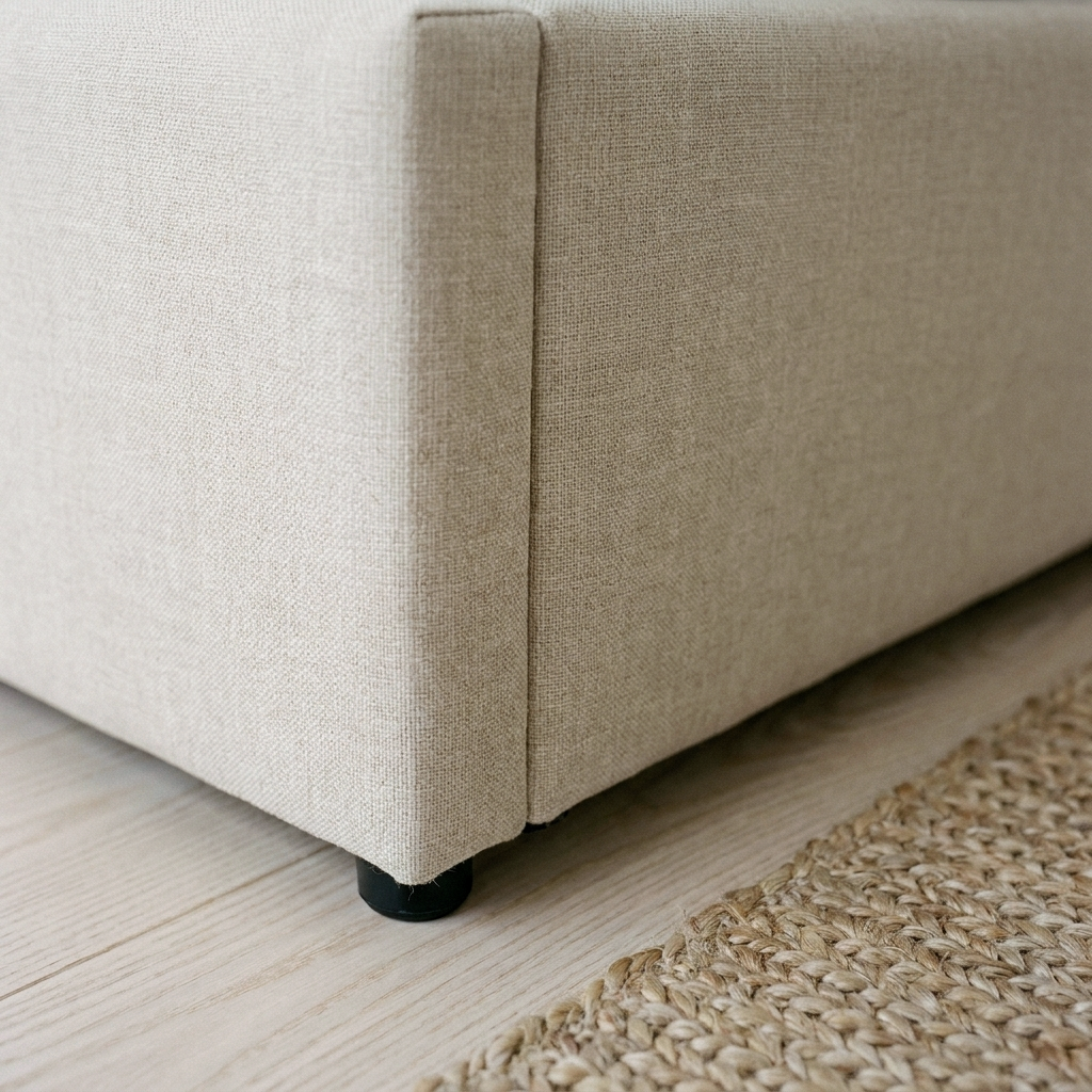 Close up of the base corner, oatmeal linen and black foot on the Kratos ottoman bed