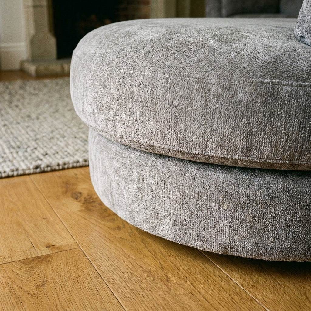 Close up of the curved plinth base and grey chenille pile on the Persia sofa