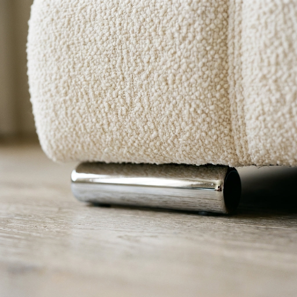 Close up of the chrome foot and cream boucle quilting on the Utopia ottoman bedframe