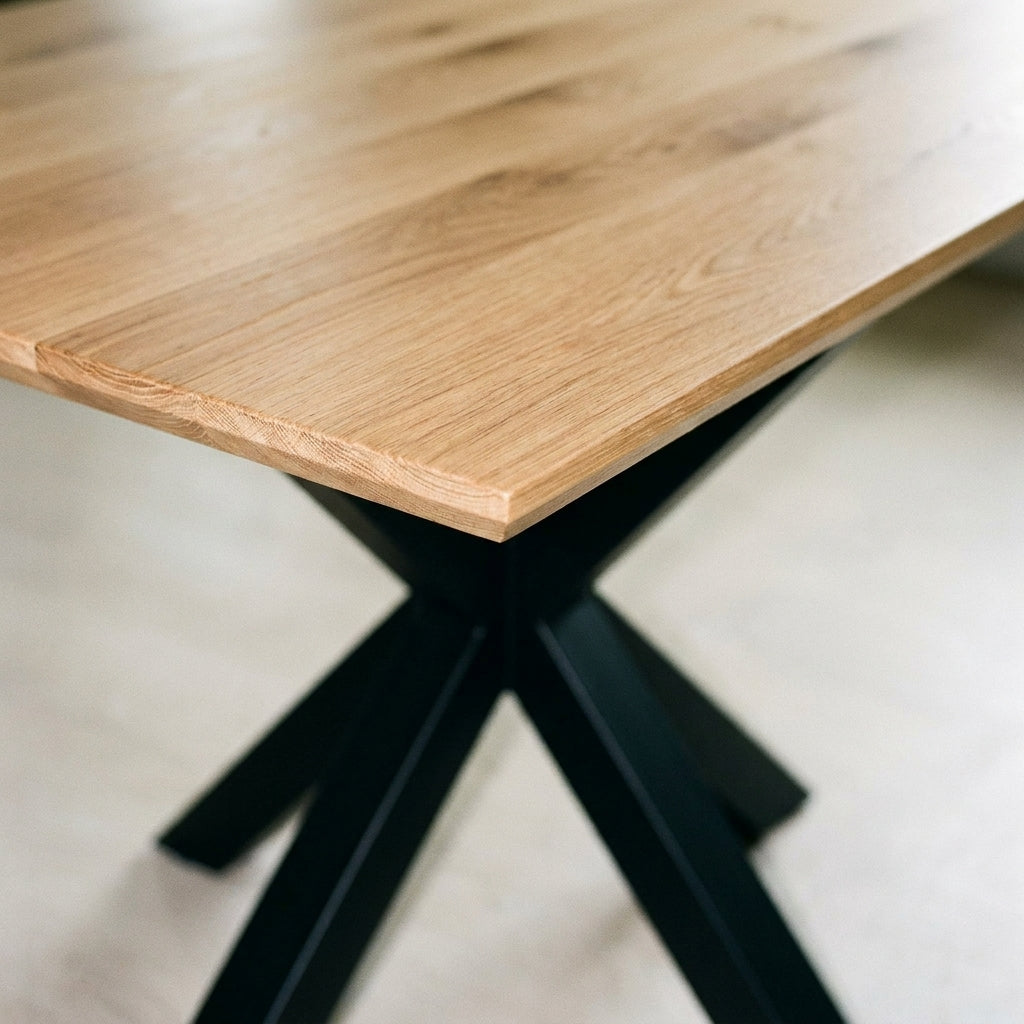 Close up of the light oak table corner and black crossed X leg on the Moore corner bench dining set