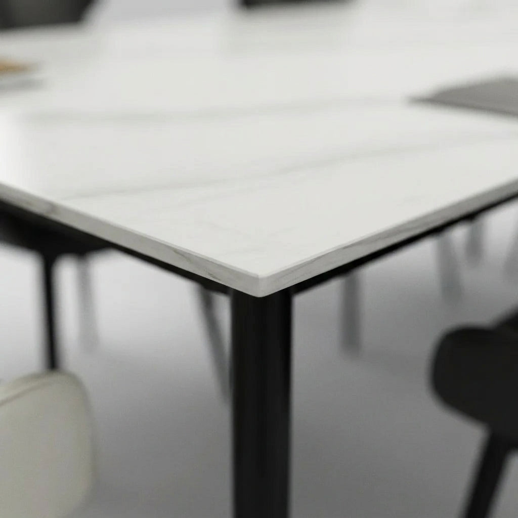 Close up of the white sintered ceramic table top corner and slim black leg on the Aramis dining set