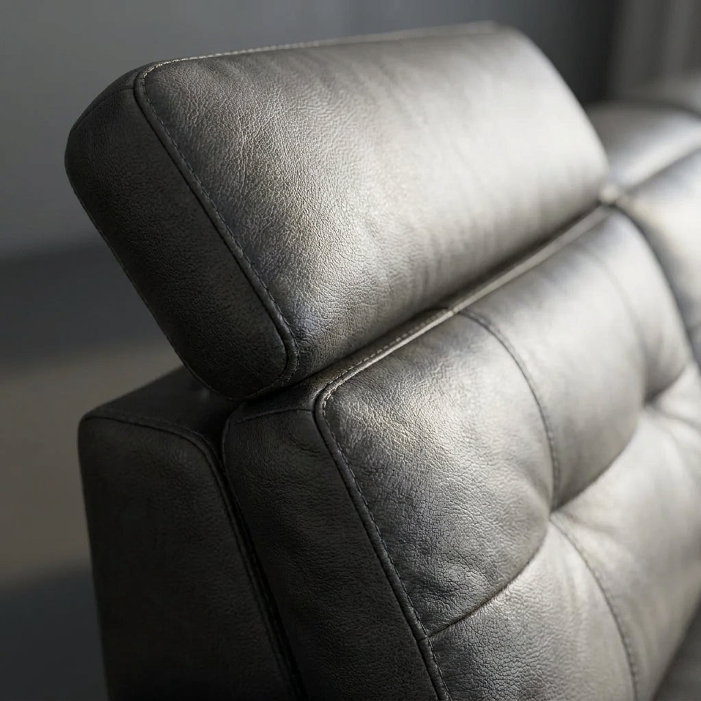 Close up of the split padded headrest raised on its hinge on the Julius charcoal leather recliner