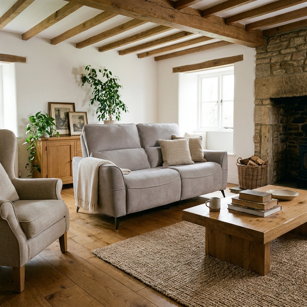 Dune light grey suede electric recliner in a beamed cottage living room with a stone fireplace