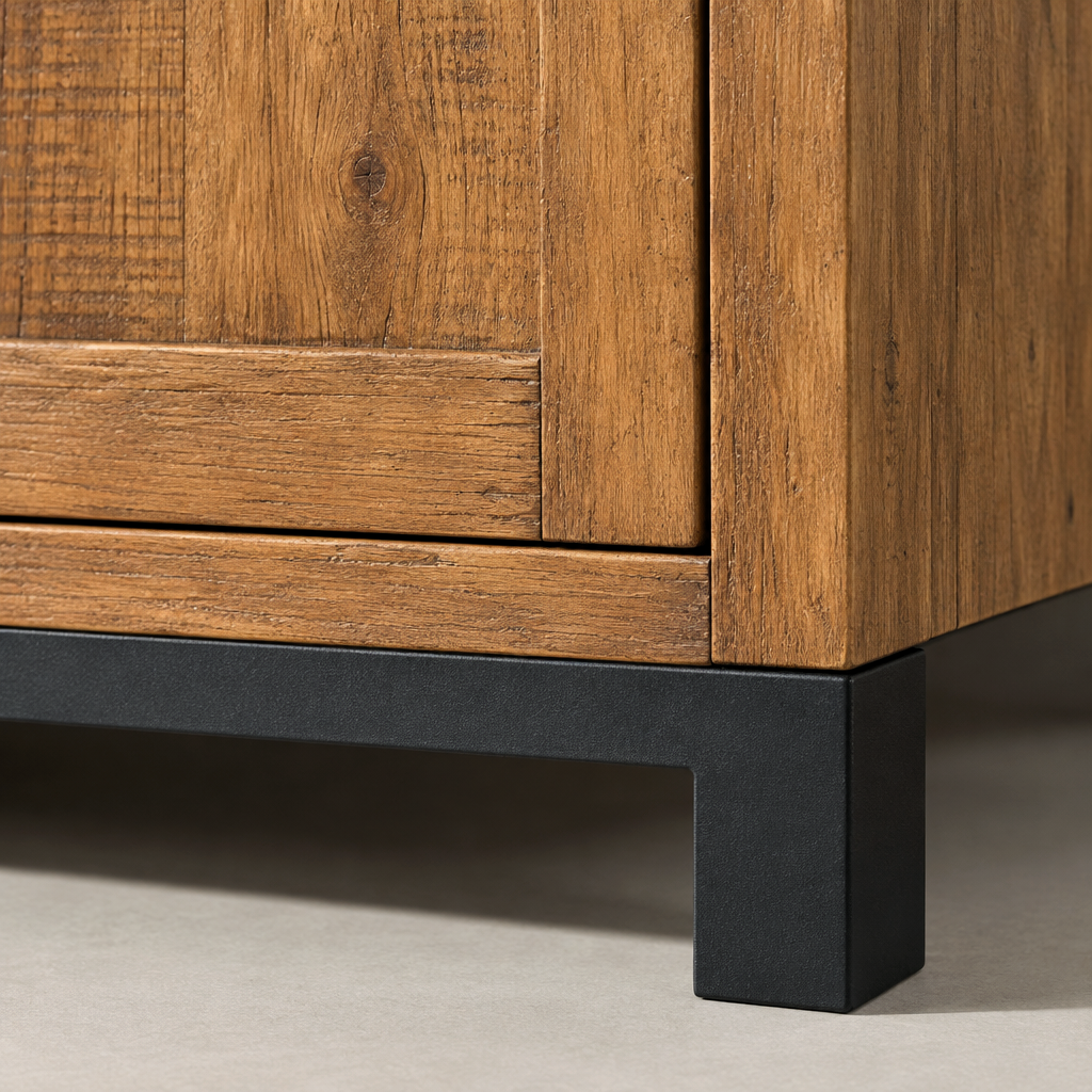 Close-up of the Jennifer sideboard black metal plinth rail beneath the antiqued pine carcass